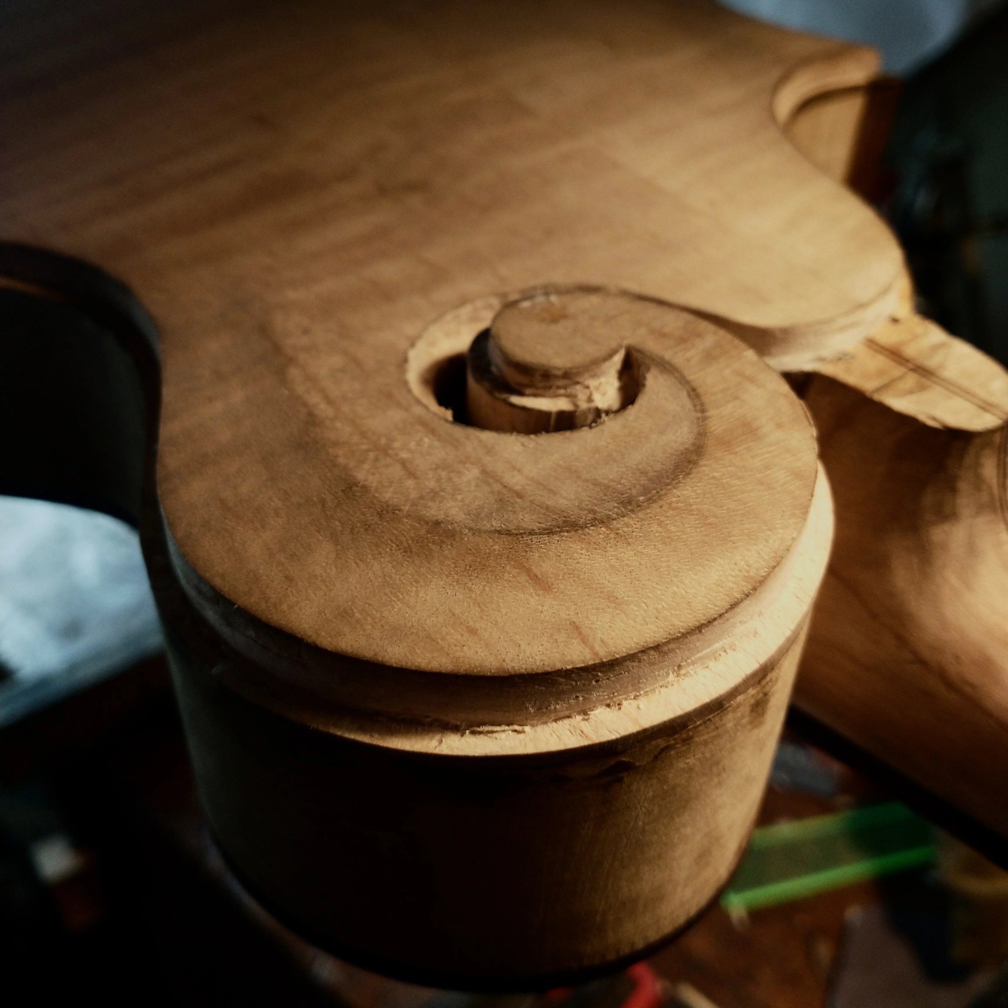 Hand-carving the F-style scroll detail