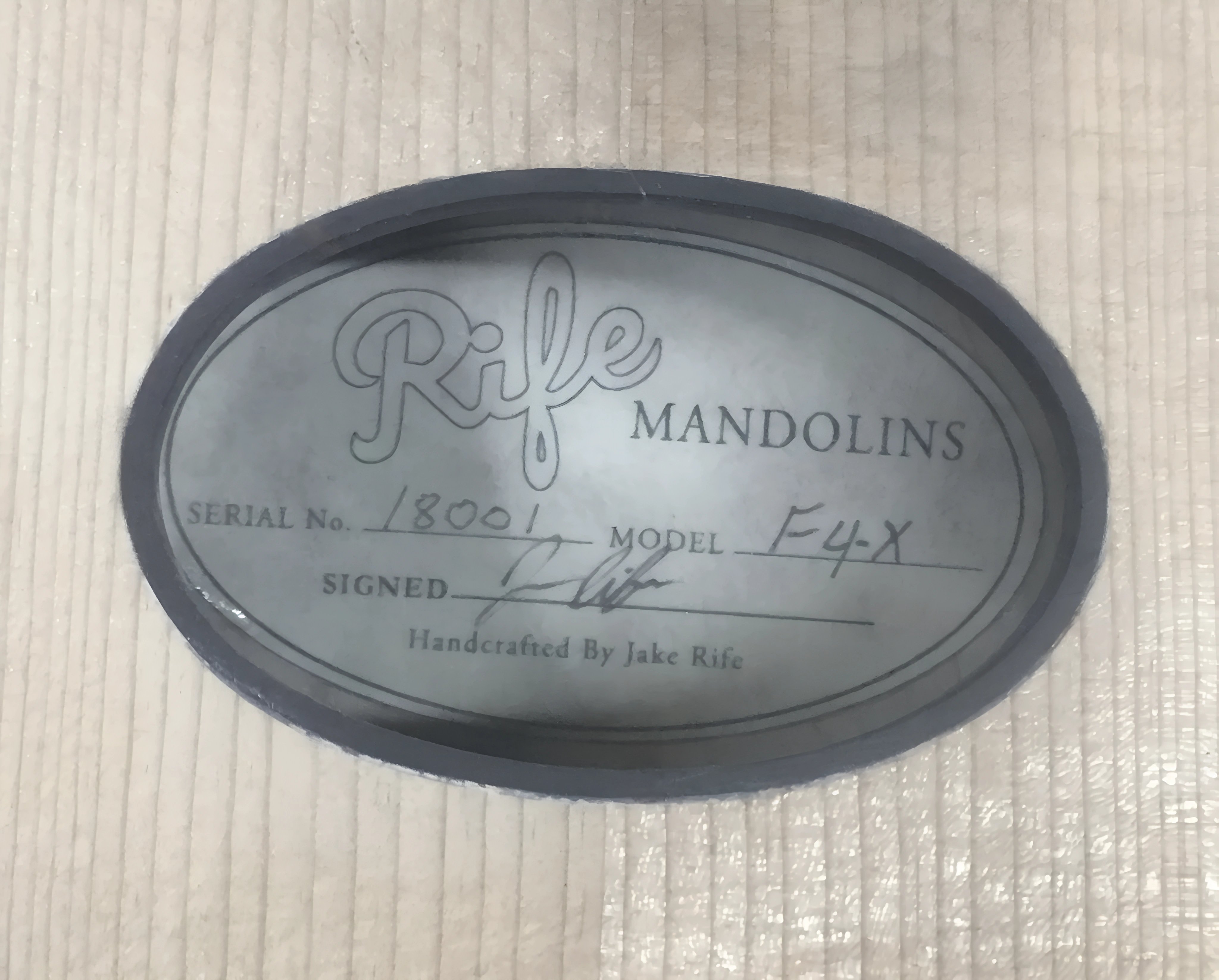 Rife Mandolins oval label on mandolin back showing serial number and signature